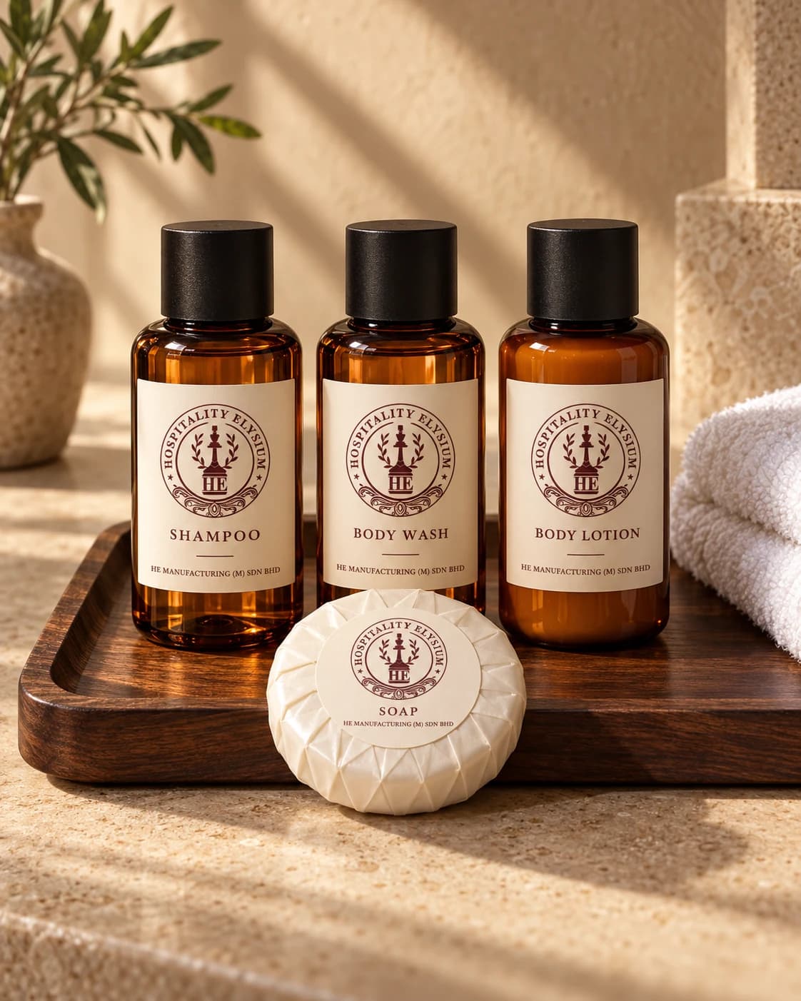 Illustrative amber HE hotel toiletries and wrapped soap on a walnut tray